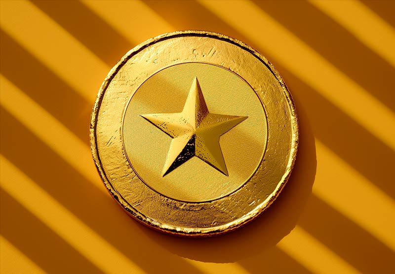 Round gold medal with a star in the center on a diagonally striped yellow background